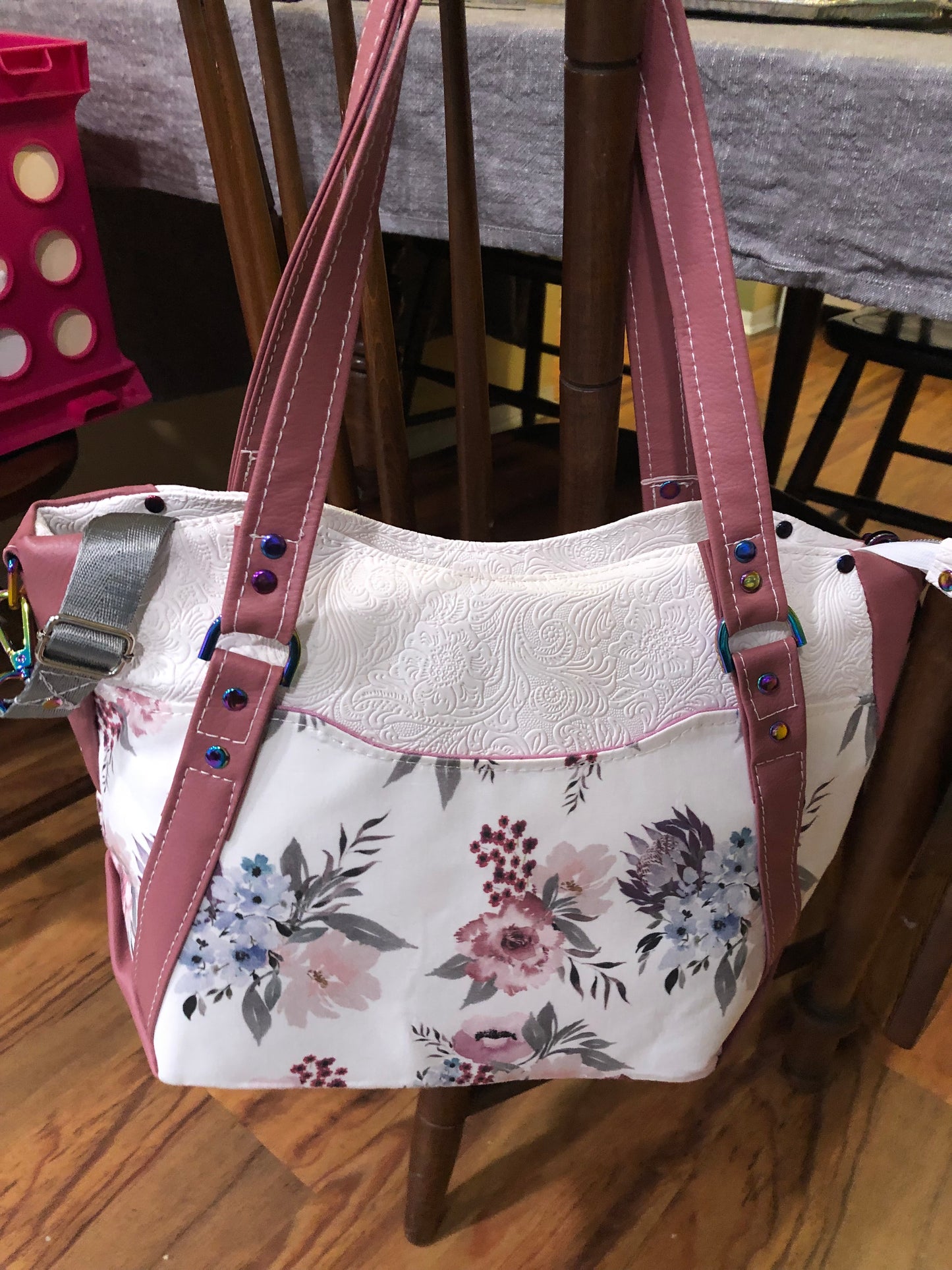 beautiful one of a kind handbag/shoulder bag with extra crossbody strap. This bag has two exterior slip pockets with additional pockets on the inside. There is also a zipper pocket inside There is also attached keyfob on the inside so you will never loose your keys.