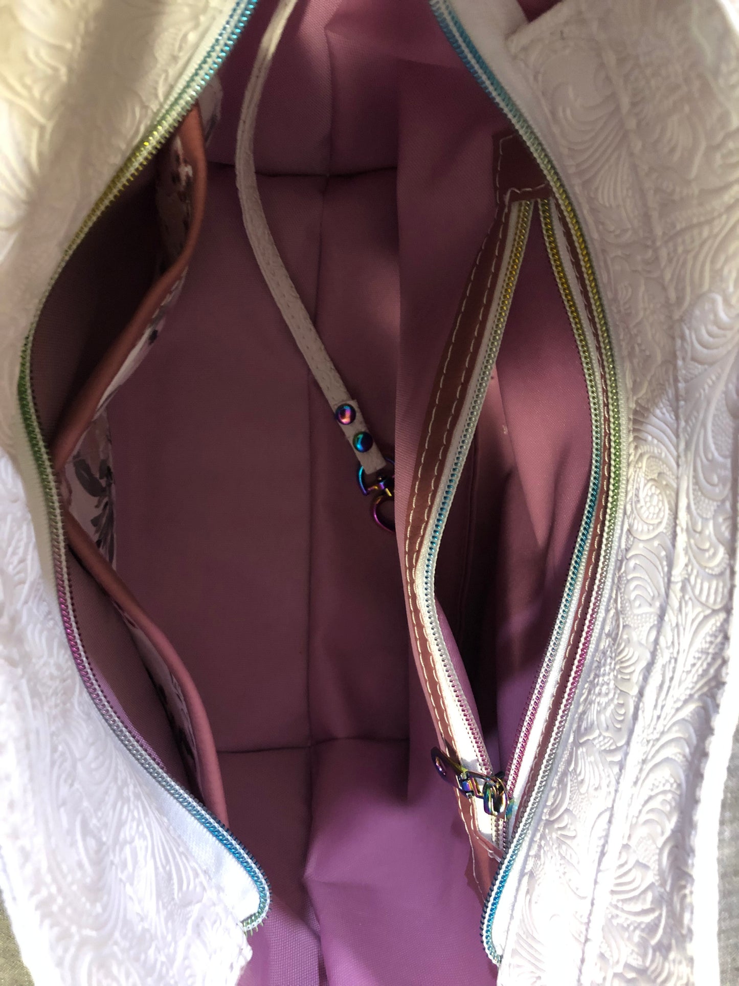 beautiful one of a kind handbag/shoulder bag with extra crossbody strap. This bag has two exterior slip pockets with additional pockets on the inside. There is also a zipper pocket inside There is also attached keyfob on the inside so you will never loose your keys.