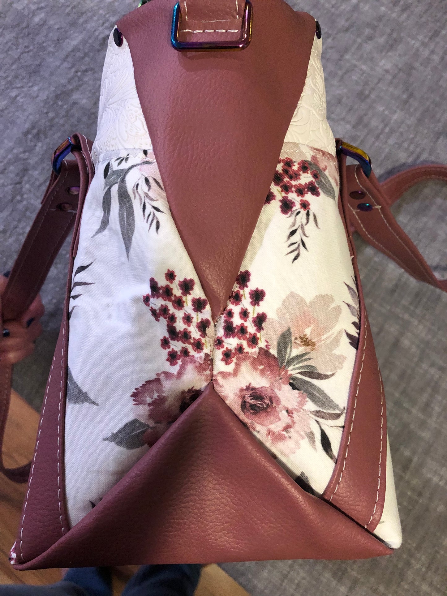 beautiful one of a kind handbag/shoulder bag with extra crossbody strap. This bag has two exterior slip pockets with additional pockets on the inside. There is also a zipper pocket inside There is also attached keyfob on the inside so you will never loose your keys.