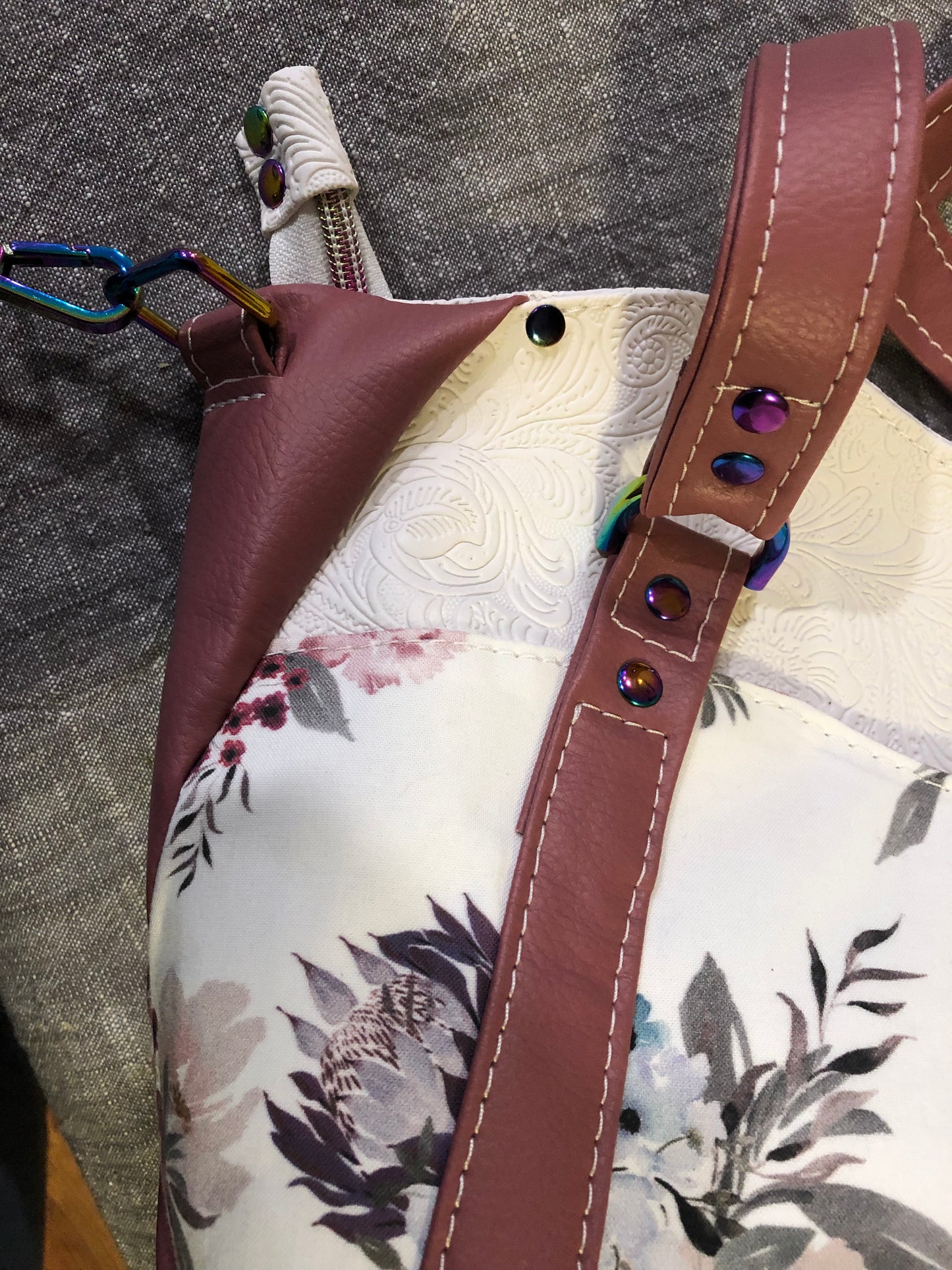 beautiful one of a kind handbag/shoulder bag with extra crossbody strap. This bag has two exterior slip pockets with additional pockets on the inside. There is also a zipper pocket inside There is also attached keyfob on the inside so you will never loose your keys.