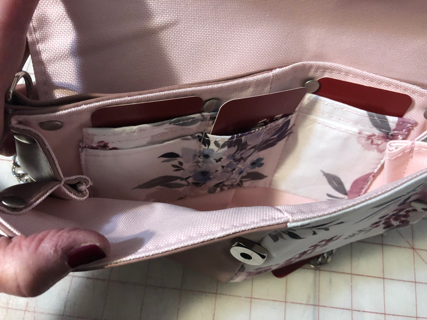 10" x 7" clutch mini purse/wallet on a chain. Card slots and enough space for a cell phone. Rosey mauve, light pink ad a beautiful cotton floral. Front snap closure. Use for an evening out with a wristlet strap or hands free with a shoulder legnth/cross body42" removable chain plus a removable wristlet strap 15" around.