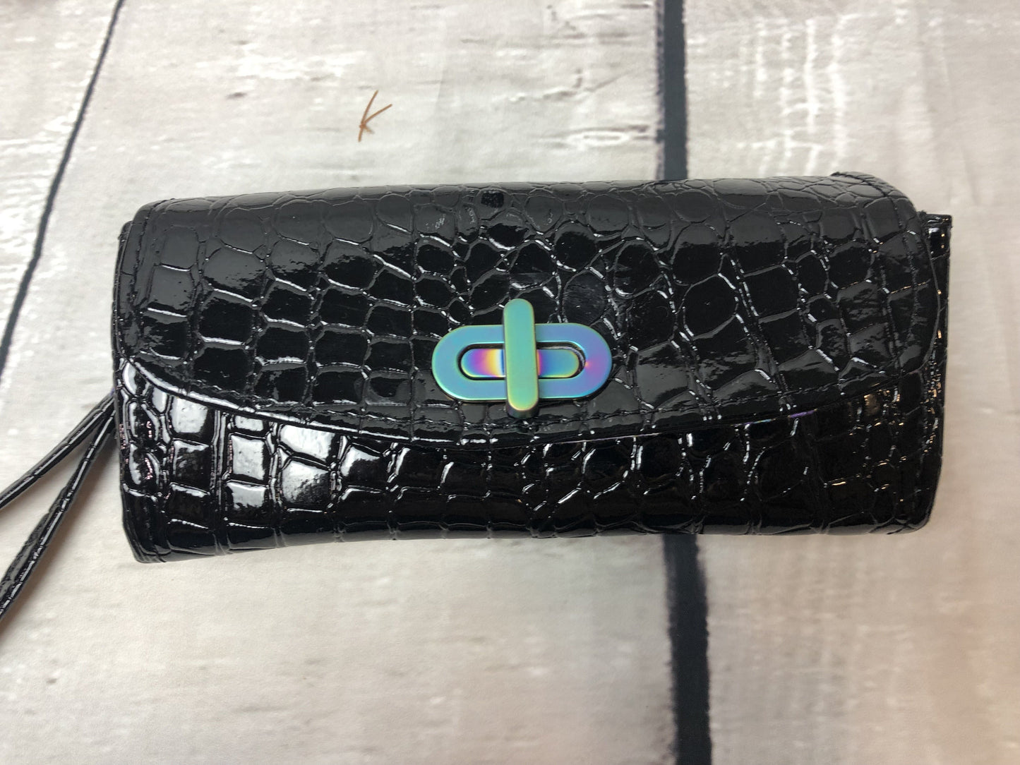 Black crocodile wallet with rainbow hardware twist lock and rivets. The interior is made with quality floral cotton fabric in beautiful purple and blue flowers. Removable wristlet strap.