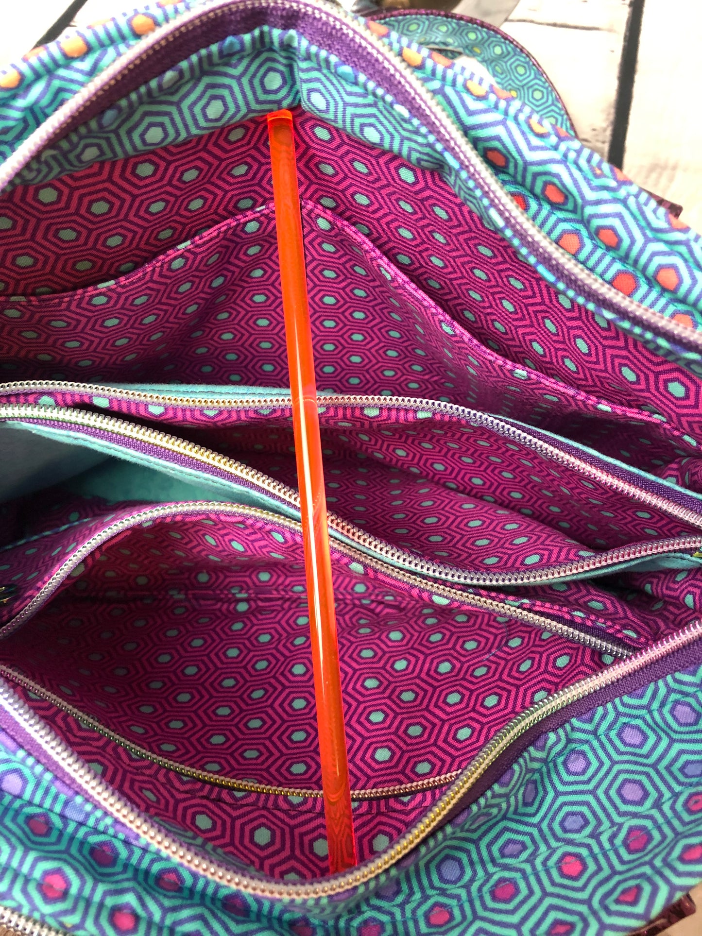 6 interior pockets. Center divider pocket is large and has a zipper closure.