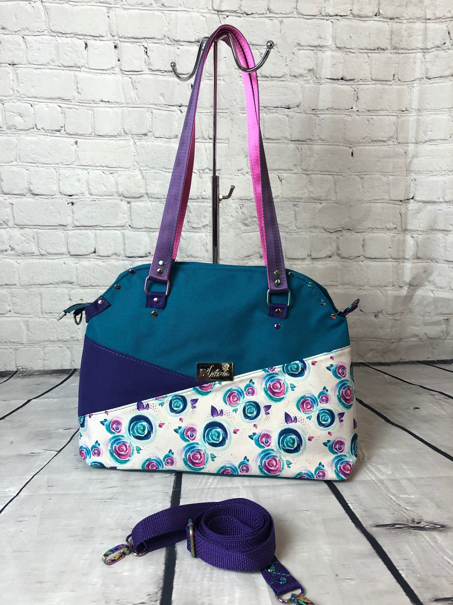 Please see other pictures for better picture of teal canvas. Josefa shoulder bag with crossbody strap. Sunglass loop on the exterior and pink/purple straps.