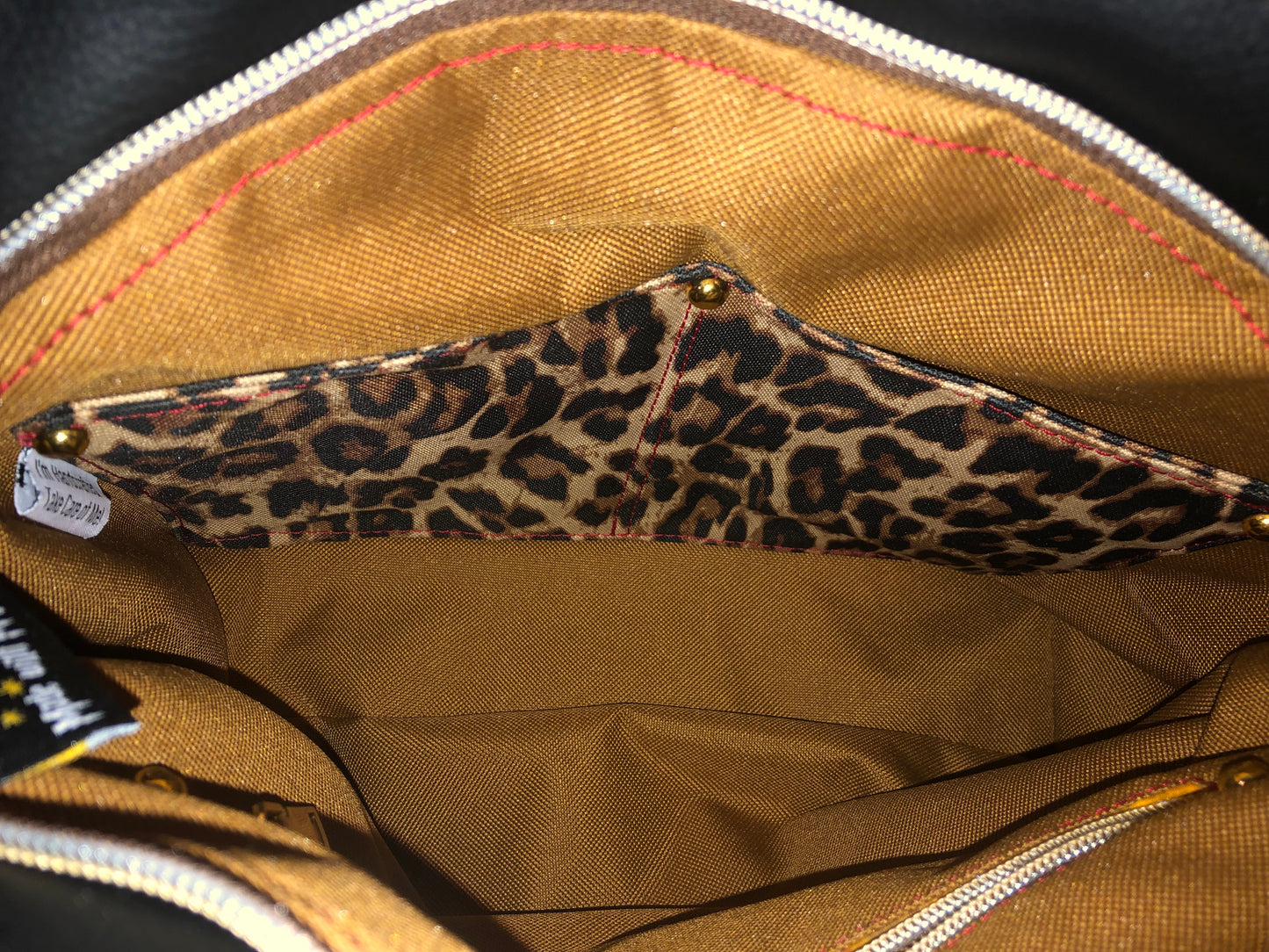 Mustard yellow/gold waterproof canvas. 1 zipper pocket and 2 slip pockets in a spacious large bag