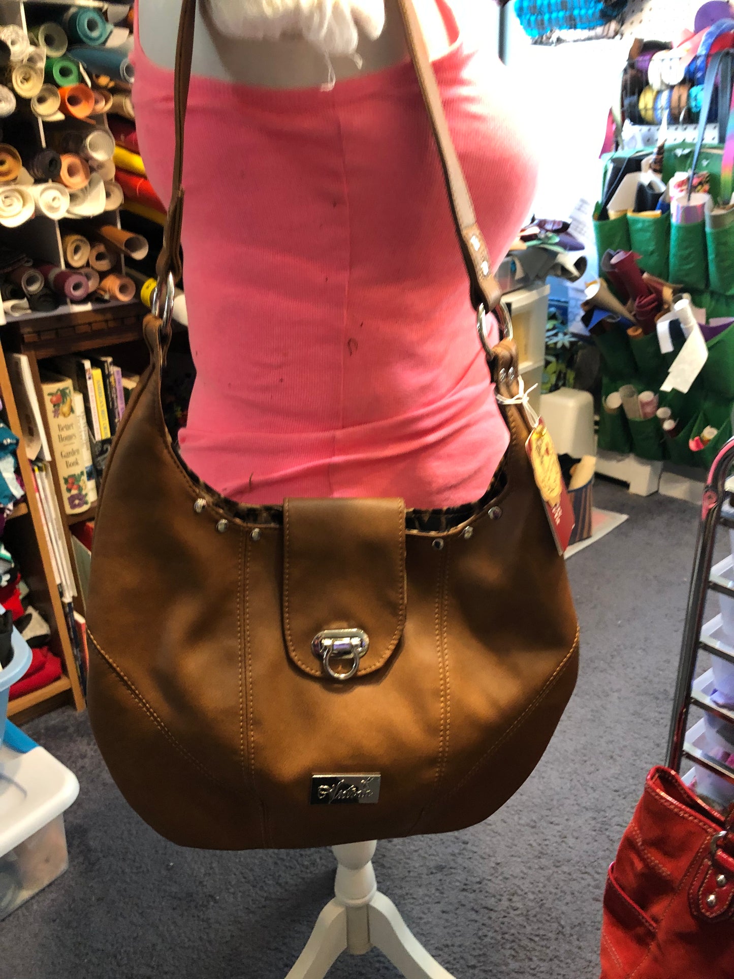 Hobo in tan with animal print canvas interior.