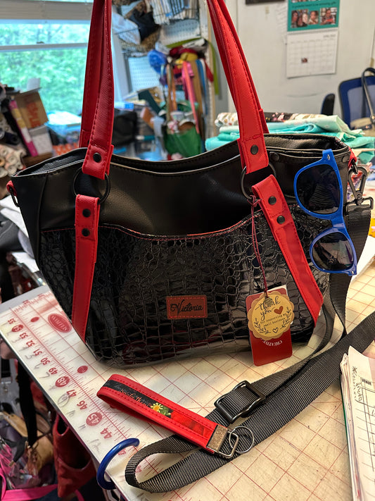 Black crock on black with red handbag