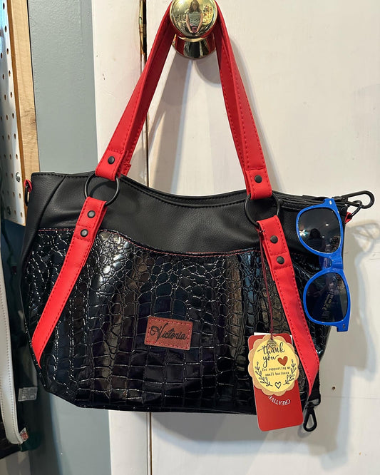 Black crock on black with red handbag