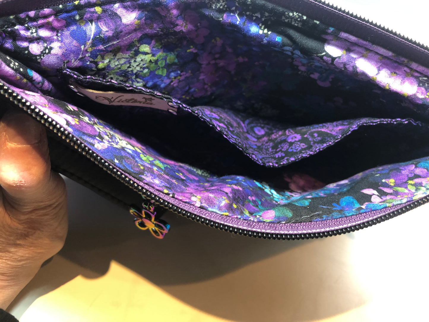 This is a great size clutch. The color purple is amazing! Extra slip for your cell will keep it safe from keys or anything else from scratching it.