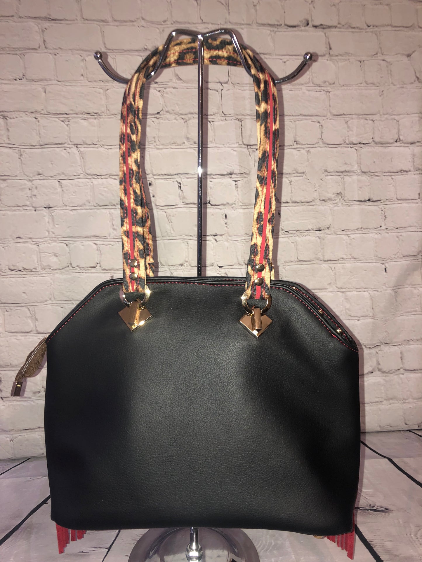 Large statement handbag. Red leather trim, leopard waterproof canvas front with black vinal backing.