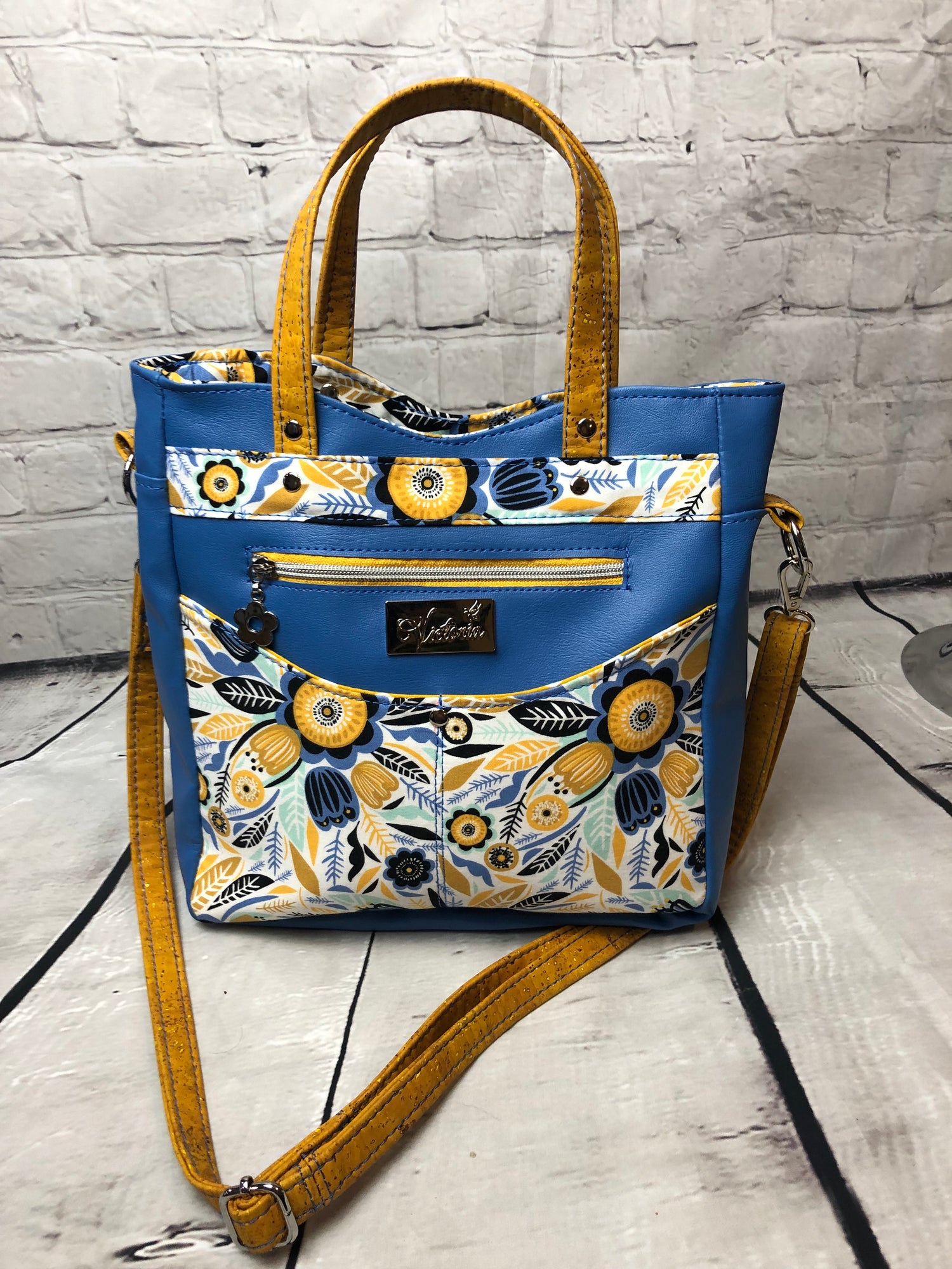 Perfect size custom bag with beautiful floral fabric,. Cork handle's and crossbody strap Extra zipper pocket on front side.