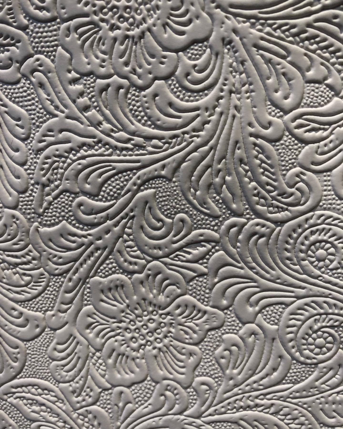 tooled filigree pattern on white vinyl.