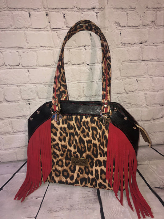 Large statement handbag. Red leather trim and waterproof canvas leopard front and bottom. Black vinyl