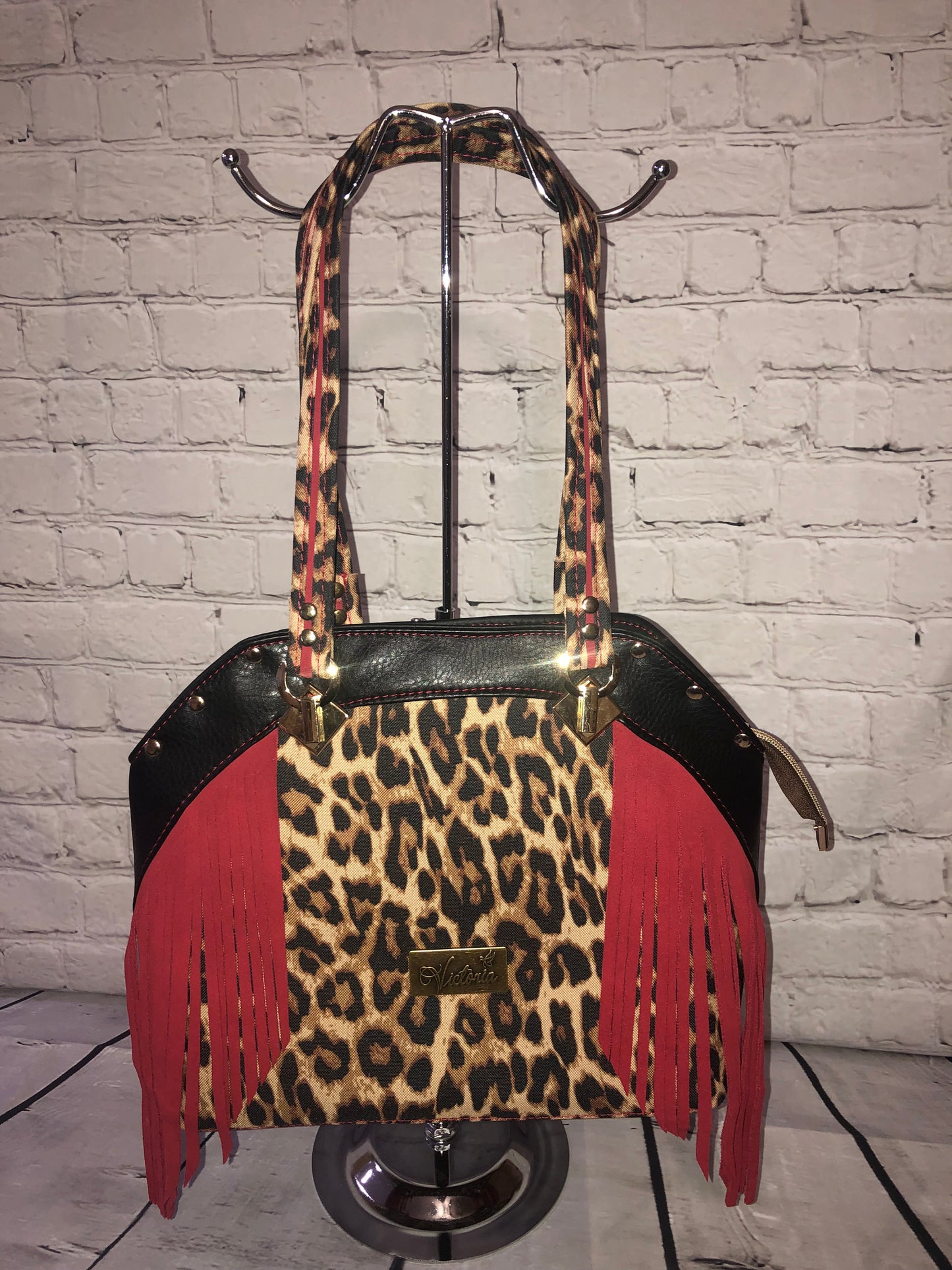 Large statement handbag. Red leather trim and waterproof canvas leopard front and bottom. Black vinyl