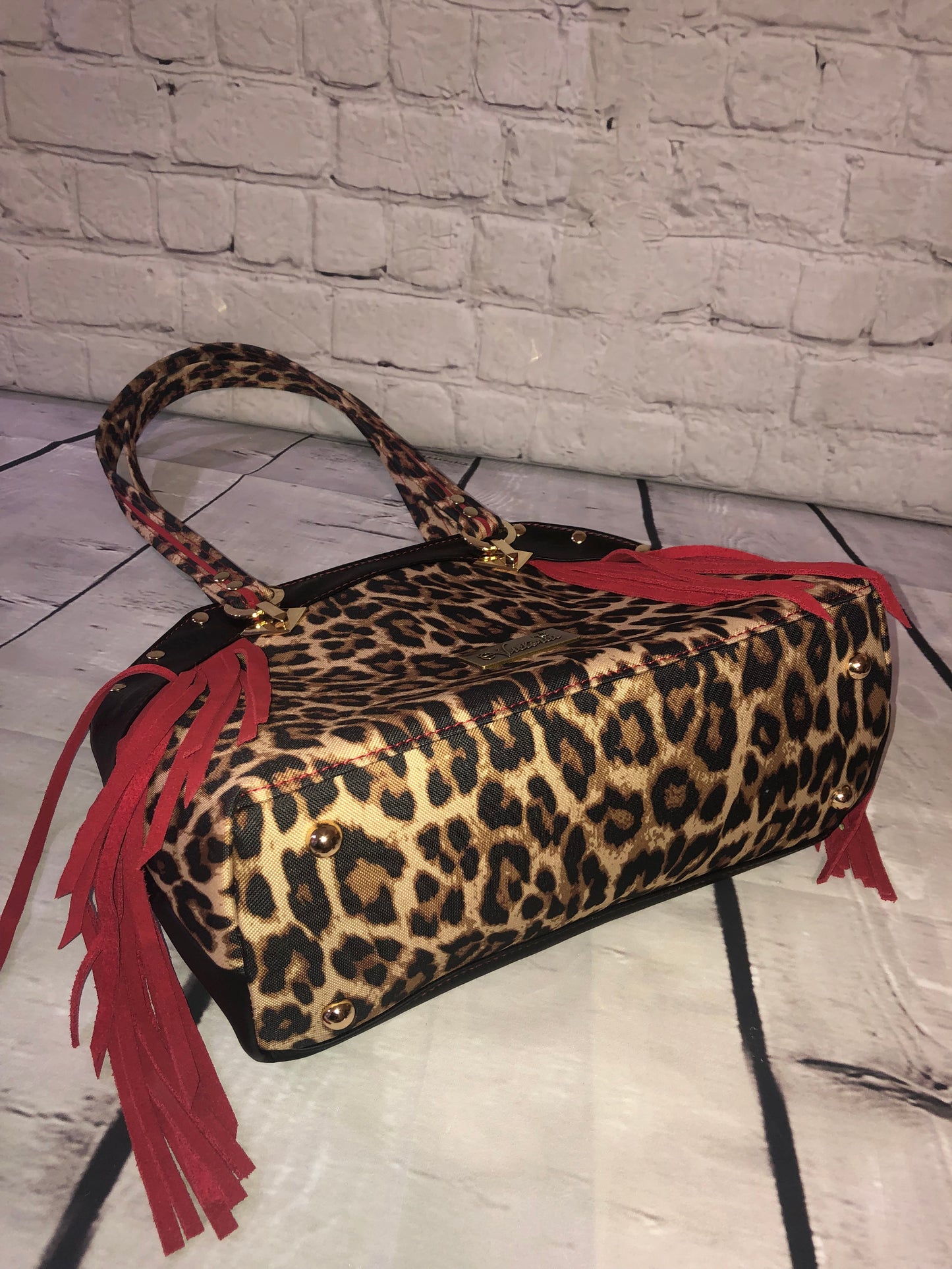 Large statement handbag. Red leather trim, leopard waterproof canvas and canvas bottom with golg finish purse feet