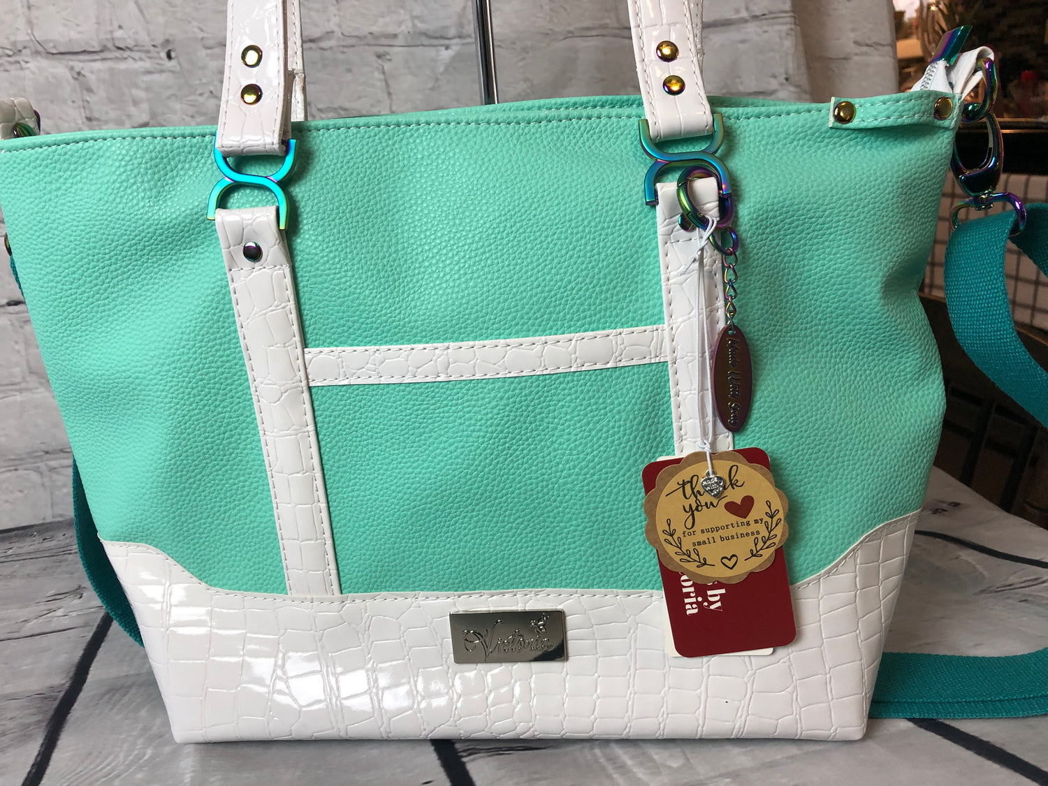 Tagged and ready to ship!Cici tote bag with lots of extras. This is a beautiful color that shouts sunny warm weather and summertime! Gorgeous rainbow hardware and white crockadail vinyl.