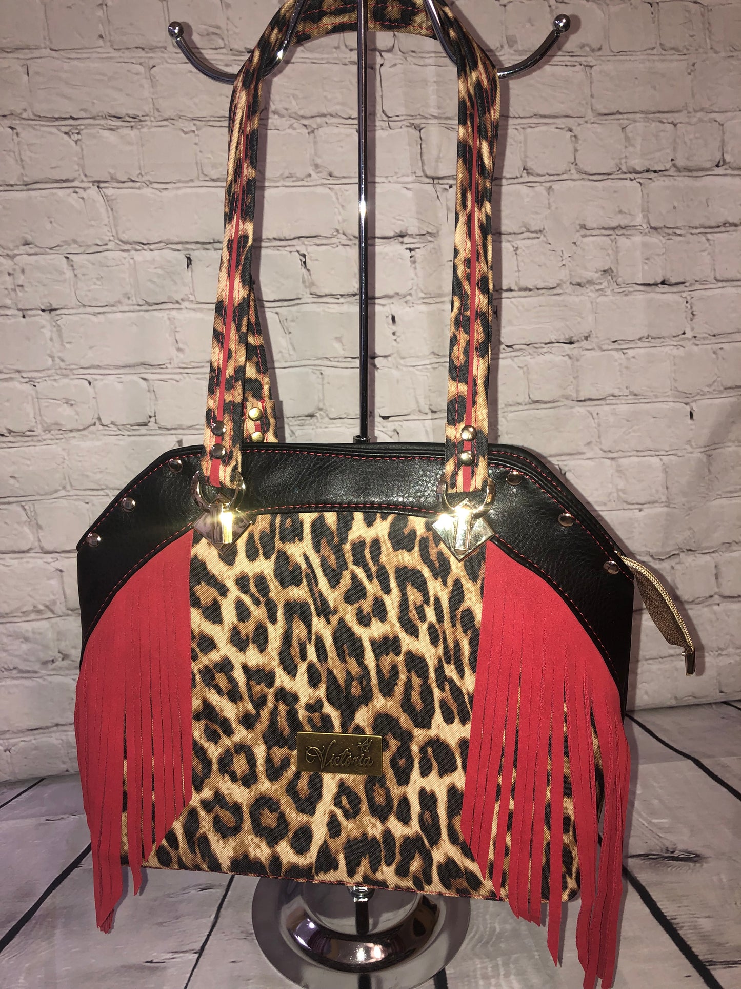 Large statement handbag. Red leather trim and waterproof canvas leopard front and bottom. Black vinyl