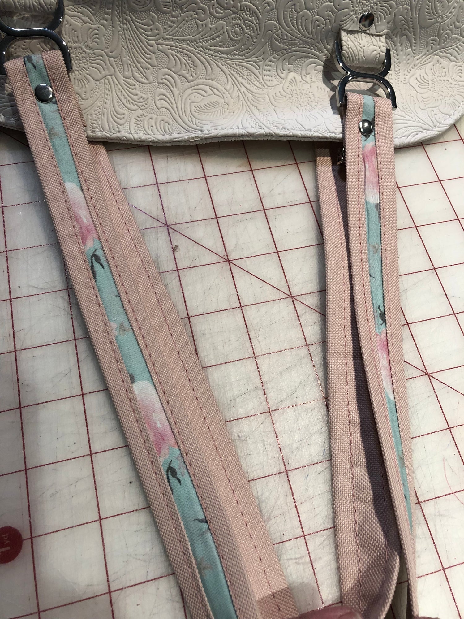 Two tone straps made with pink canvas wrapping around the green floral fabric