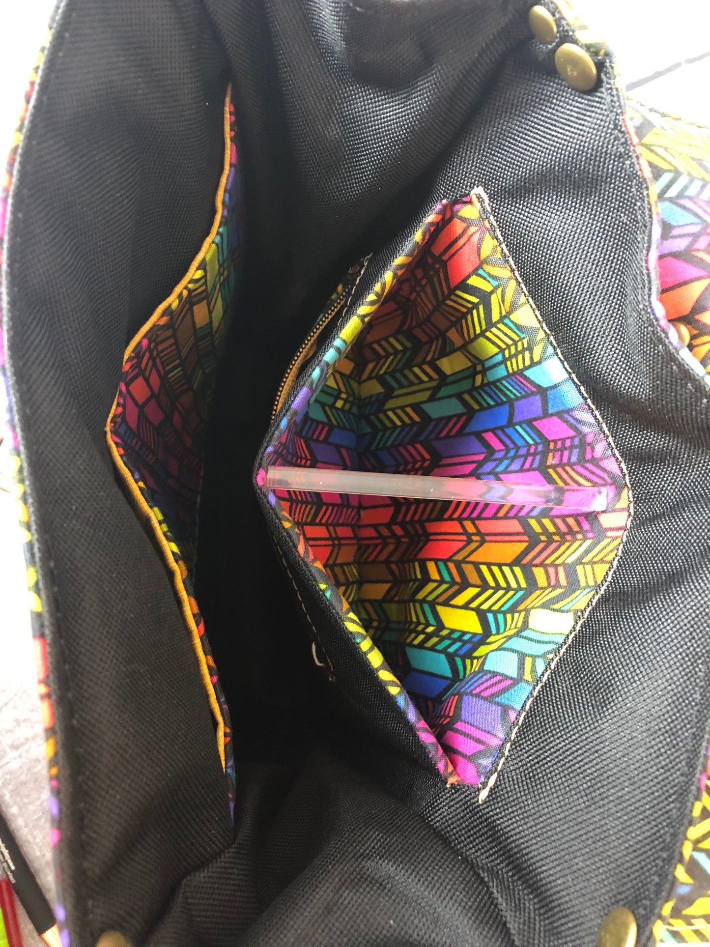 Looking into the black canvas interior. Meraki leather trim backpack with designer Anna Marie colorful fabric.. (there is a piece of acrylic holding the pocket open.)