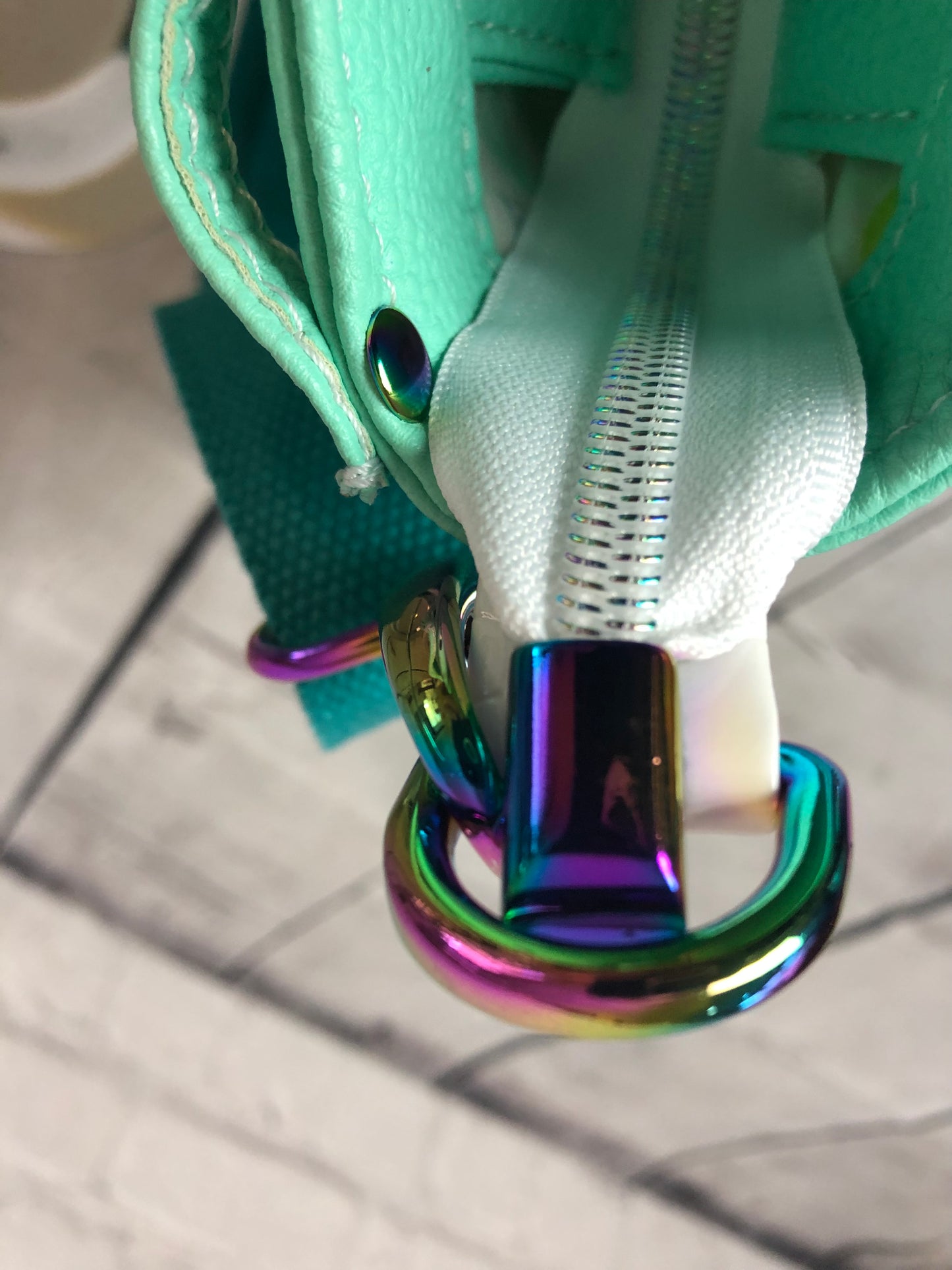 Side connector d ring and zipper end. Both in fantastic rainbow! Cici tote bag with lots of extras. This is a beautiful color that shouts sunny warm weather and summertime! Gorgeous rainbow hardware and white crockadail vinyl. 